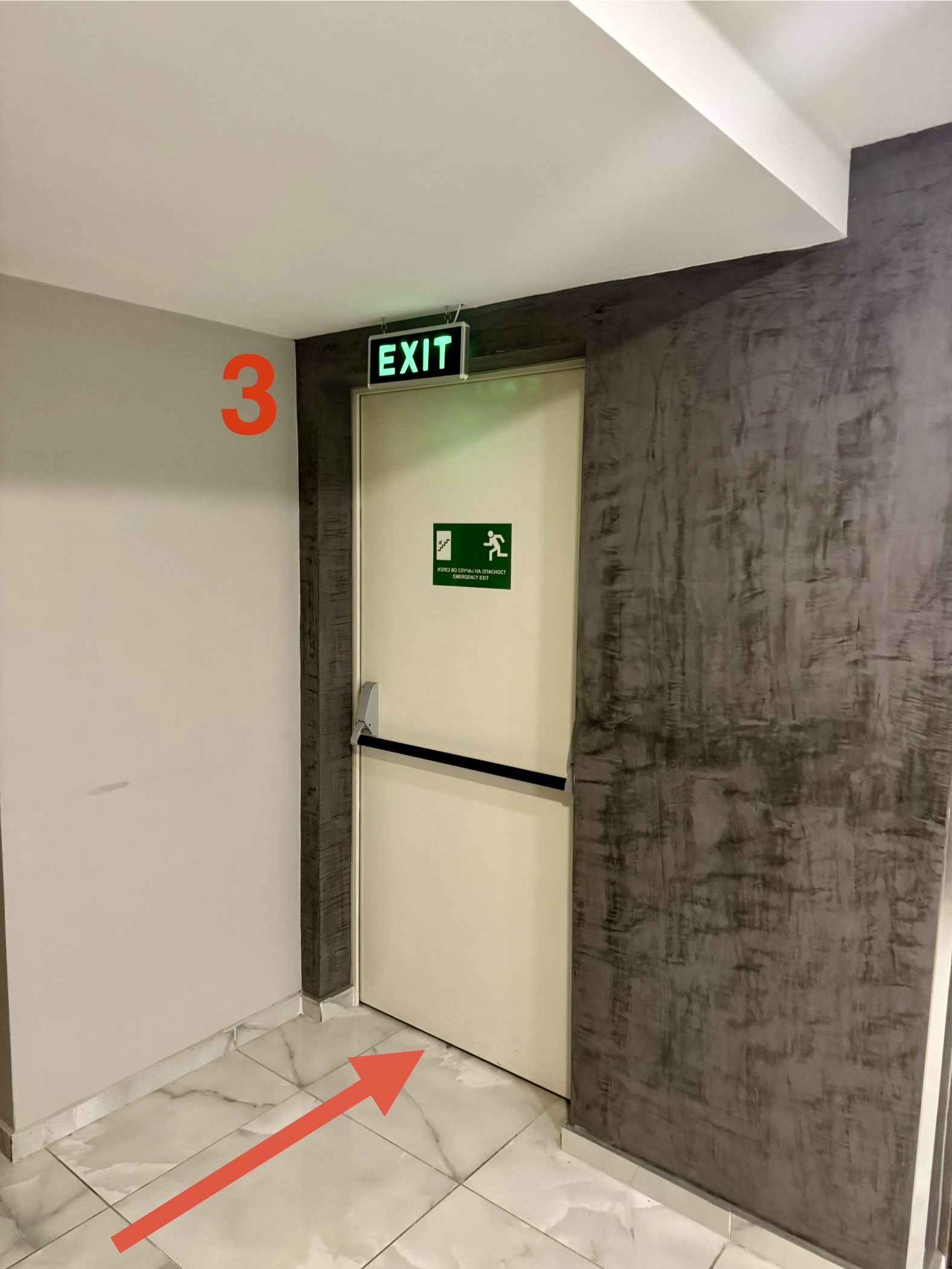 Enter emergency exit door with green EXIT sign